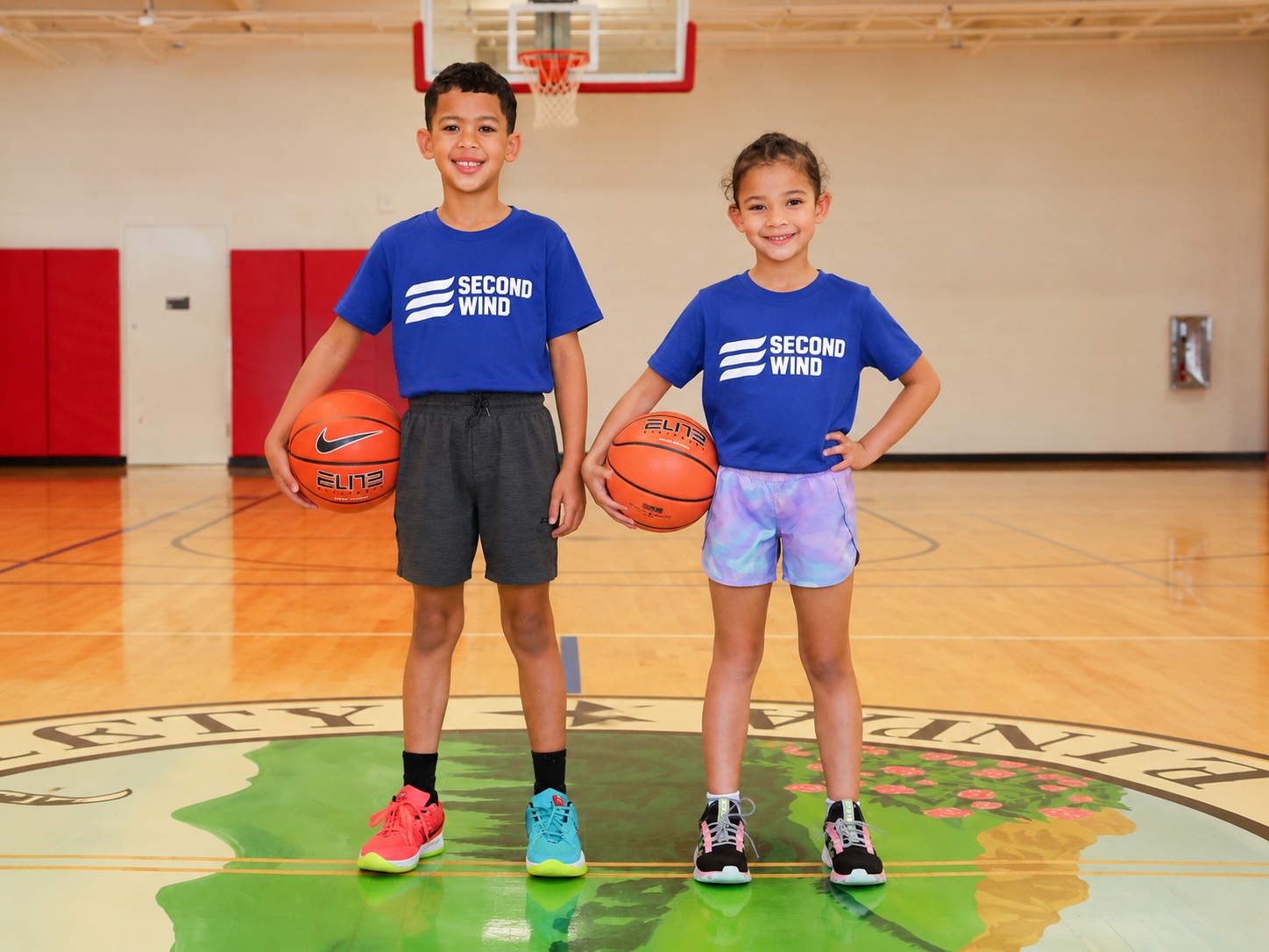 Young basketball players wearing Second Wind shirts in a gym